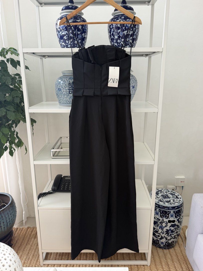 Zara Black Strapless Jumpsuit Size S (Category: Jumpsuits) located in Lipa City. Submitted by pauline0303 (Listing ID 1470174741, Image 3). Description: - Brand: Zara - Style: Strapless wide-leg jumpsuit with optional thin spaghetti straps - Size: Small (S) - Color: Classic Black - Features: Structured bodice, elegant pleating details, and secure back zipper closure, side pockets - Condition: Brand new with original tags attached (BNWT), never wo