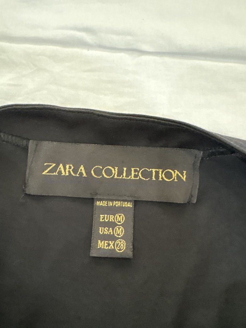Zara Collection Butterfly Wing Neckline (Category: Blouses) located in Muntinlupa City. Submitted by jane226ph (Listing ID 1470134844, Image 3). Description: Original Zara Collection Black Unique shiny cut-out butterfly wing details at the front, short puff sleeves, pleated. Bought in Spain Purchased in-store An older collection of Zara. Rare design..