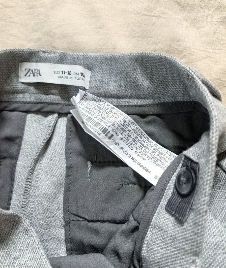 Zara Grey Trousers Size 11-12 (Category: Trousers) located in Tacloban City. Submitted by thead.declutters (Listing ID 1470204405, Image 3). Description: - Brand: Zara - Size: 11-12 years (152 cm) - Color: Grey - Style: Classic tailored fit with belt loops - Pockets: Front pockets and two back welt pockets - Origin: Made in Turkey - Condition/Use: Great for school uniforms or formal events.