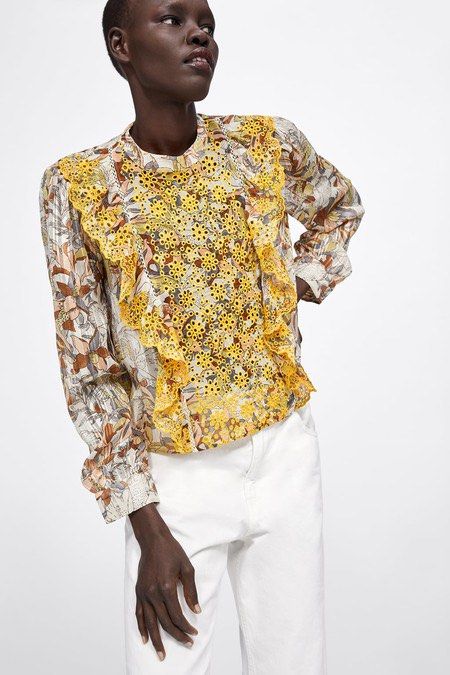 Zara Printed Ruffle Embroidered Eyelet Blouse (Category: Blouses) located in Paranaque City. Submitted by cutie.cooky (Listing ID 1470292981, Image 1). Description: - Multicolor printed long sleeve blouse - Yellow eyelet lace panels down the front - Chic ruffle trim along shoulders and chest - High neck style with button cuffs - Condition: Worn a few times, washed and stored carefully - Versatile statement piece for work or casual weekends XS-S.