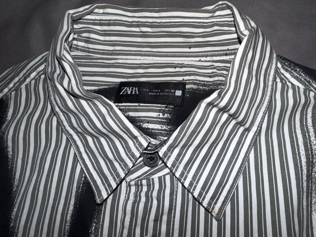 Zara Short Sleeve Shirt (Category: Tshirts & Polo Shirts ) located in Taguig. Submitted by j.lax. (Listing ID 1470330783, Image 2). Description: - Brand: Zara - Size: L - Color: Black and white vertical stripes with bold spray paint graffiti print.