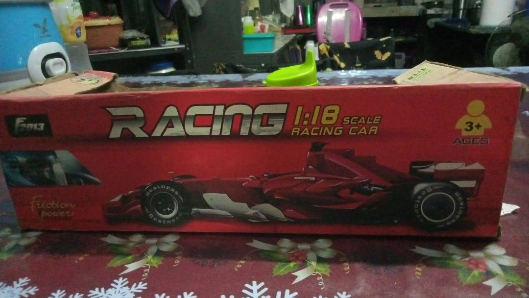 1:18 Scale Red Racing Car Toy (Category: Vehicle & Diecast Models) located in Manila. Submitted by wisegem-231b (Listing ID 1470397606, Image 2). Description: - Scale: 1:18 - Type: Friction-powered red racing car - Condition: Brand new, toy is untouched inside - Packaging: Box has minor wear on edges and corners, with transparent windows on front and top - Ideal for: Toy vehicle collections.