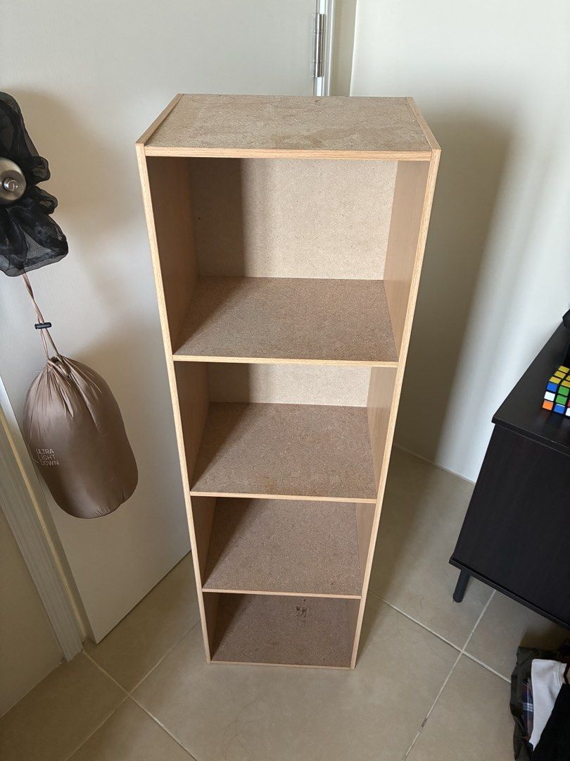 4-Tier Wooden Storage Shelf Bookcase (Category: Shelves, Cabinets & Racks) located in Las Pinas. Submitted by mrcolorless (Listing ID 1470386480, Image 1). Description: - Type: Tall wooden bookcase - Finish: Light wood with clean back panels - Storage: 4 spacious open compartments - Condition: Sturdy structure, standard upright rectangular shape - Ideal For: Storing books, binders, or displaying items - Placement: Great for bedrooms, living rooms
