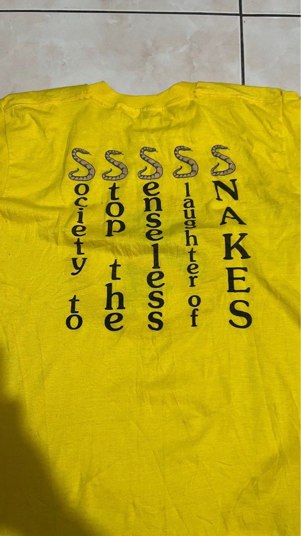 80s Stop Snake Slaughter Yellow T-Shirt (Category: Tshirts & Polo Shirts ) located in Muntinlupa City. Submitted by carl.samudio.carl.samudio56068 (Listing ID 1470480814, Image 2). Description: - Era: Authentic 80s vintage - Color: Bright yellow - Graphic: Front tire/snake no-symbol graphic with "Society to stop the senseless slaughter of snakes" vertical back text - Size: 19.5" chest x 25.5" length (Tag missing) - Condition: Has some small dot s