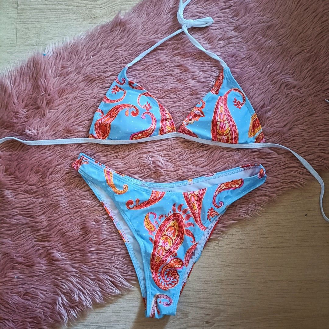 Ⓜ️ Blue Paisley Print Triangle Bikini Set (Category: Bikinis & Swimsuits) located in Bacoor. Submitted by Miss_Chuch0521 (Listing ID 1470363751, Image 1). Description: - Style: Blue bikini set with vibrant pink and orange paisley print - Top: Triangle top with adjustable white halter neck ties and back strap - Bottoms: Matching high-cut bottoms - Material: Comfortable, stretchy swim fabric - Condition: Worn only once, freshly washed and ready to 