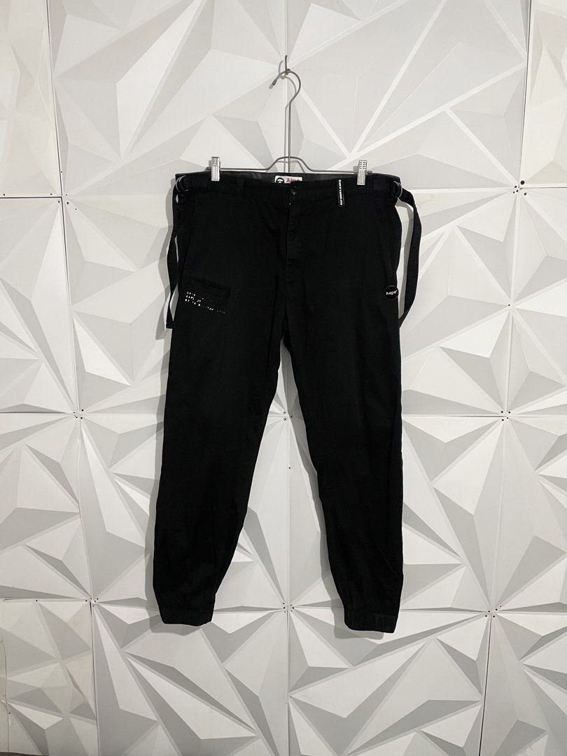Aape By A Bathing Ape Black Cargo Jogger Pants (Category: Joggers) located in Cabuyao City. Submitted by ParadisethriftedPh (Listing ID 1470547165, Image 1). Description: Issue yung iba paints nabura na Cr : 9/10 Dimensions W: 36-38 L: 39 - Brand: Aape by A Bathing Ape - Color: Solid black - Condition: Great overall - Style: Streetwear cargo joggers - Features: Side utility straps and elastic cuffs - Details: Printed graphics on front pocket and 