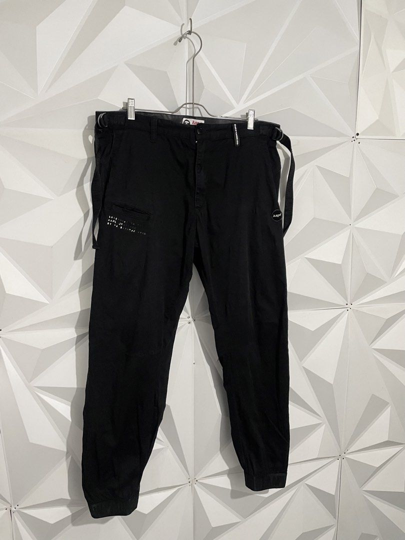 Aape By A Bathing Ape Black Cargo Jogger Pants (Category: Joggers) located in Cabuyao City. Submitted by ParadisethriftedPh (Listing ID 1470547165, Image 2). Description: Issue yung iba paints nabura na Cr : 9/10 Dimensions W: 36-38 L: 39 - Brand: Aape by A Bathing Ape - Color: Solid black - Condition: Great overall - Style: Streetwear cargo joggers - Features: Side utility straps and elastic cuffs - Details: Printed graphics on front pocket and 