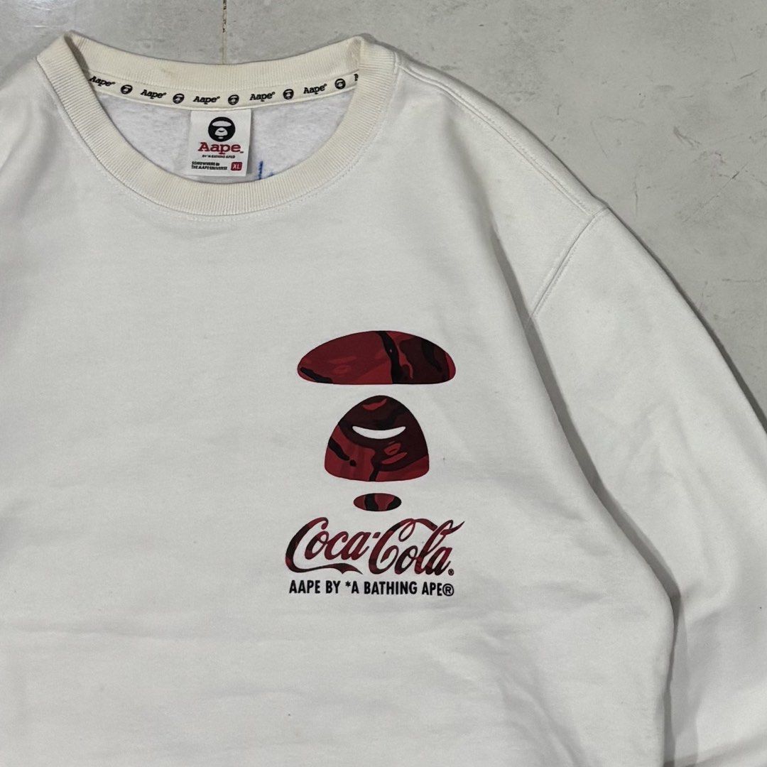 Aape x coca cola sweater (Category: Luxury Apparel) located in Cebu City. Submitted by florianmiral28 (Listing ID 1470354670, Image 2). Description: Aape x coca cola sweater Excellent condition XL W 23 L 27.