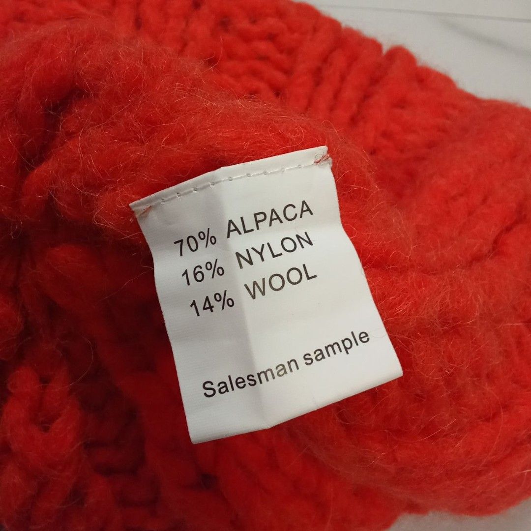 Acne Studios - Sample - Cable Knit - Wool Large Beanie (Category: Beanies) located in Manila. Submitted by grmnts_frmthe_slmz (Listing ID 1470451970, Image 3). Description: Acne Studios knit beanie in bright orange. Chunky rib knit texture, folded cuff style with brand label patch on front. Fabric tag inside indicates 70% alpaca, 16% nylon, 14% wool blend, marked as a salesman sample. Warm, soft material, thick weave. Acne Studios - Sample - Rope
