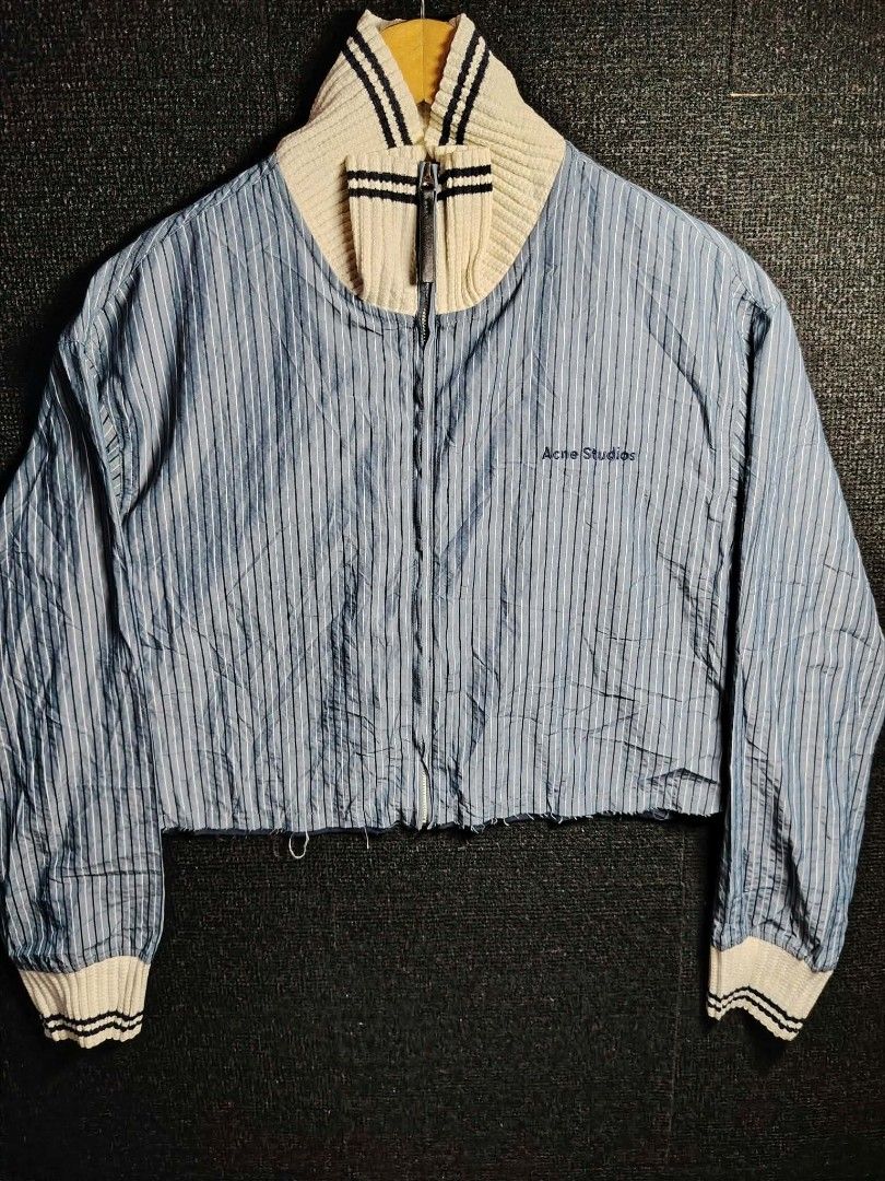Acne Studios Striped Zip Jacket (Category: Coats, Jackets and Outerwear) located in Baguio. Submitted by tabuzomaria1422 (Listing ID 1470484551, Image 1). Description: - Brand: Acne Studios - Color/Pattern: Blue and white striped - Origin: Made in Japan - Details: High ribbed collar with dark stripes, zipper closure with leather pull tab, small embroidered chest logo, ribbed cuffs - Condition: 100% material tag visible inside, well-maintained.