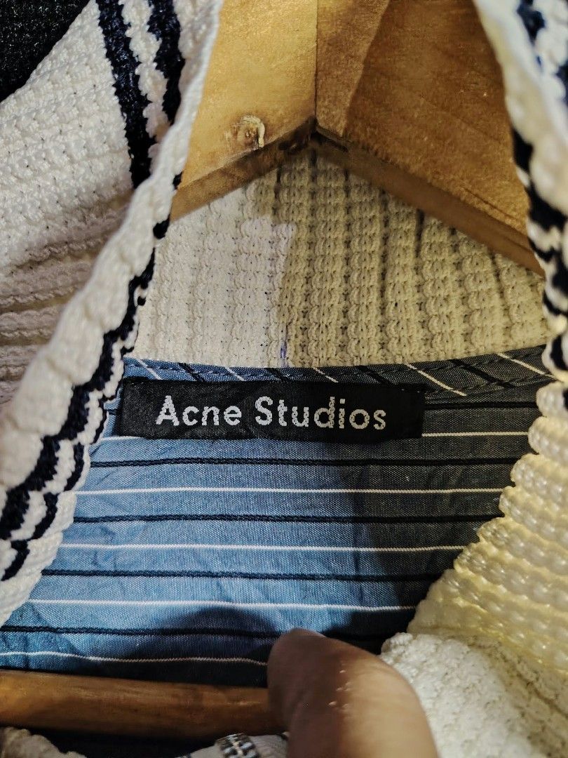 Acne Studios Striped Zip Jacket (Category: Coats, Jackets and Outerwear) located in Baguio. Submitted by tabuzomaria1422 (Listing ID 1470484551, Image 3). Description: - Brand: Acne Studios - Color/Pattern: Blue and white striped - Origin: Made in Japan - Details: High ribbed collar with dark stripes, zipper closure with leather pull tab, small embroidered chest logo, ribbed cuffs - Condition: 100% material tag visible inside, well-maintained.