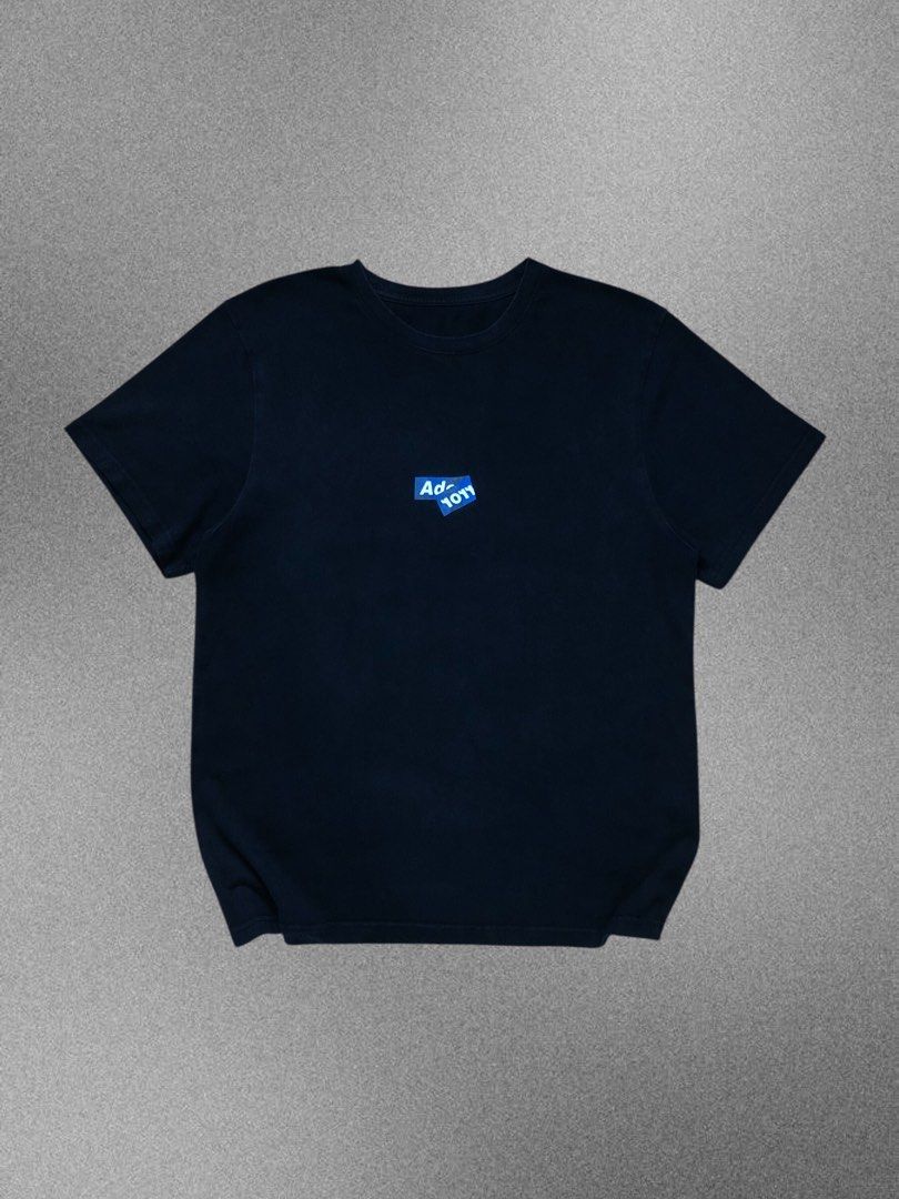 Ader Error Origin Blue Logo T-Shirt (Category: Tshirts & Polo Shirts ) located in Manila. Submitted by purewater.2554df (Listing ID 1470499583, Image 1). Description: Black short-sleeve tee from Ader Error Origin. Small blue overlapping logo graphic on the chest. Size A1 tag inside. Made in Korea. Hand wash only care label attached. Clean solid black cotton fabric, relaxed fit..