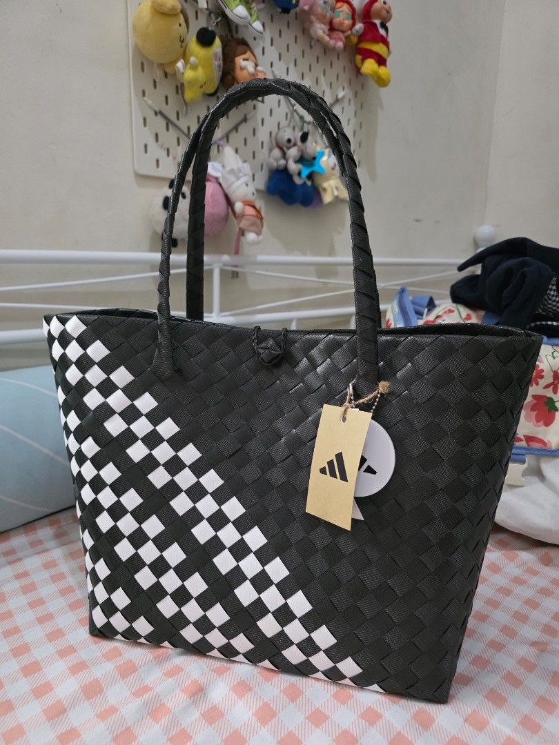 Adidas Bayongciaga (Category: Tote Bags) located in Antipolo. Submitted by pinkpandascloset (Listing ID 1470352572, Image 1). Description: - Brand new with original tags attached - Chic black and white woven design with a two-tone checked lower pattern and solid black upper - Comfortable braided handles and a structured rectangular base - Spacious roomy main compartment for everyday essentials - Never used and in pristine condition ✨️Weekend Decl