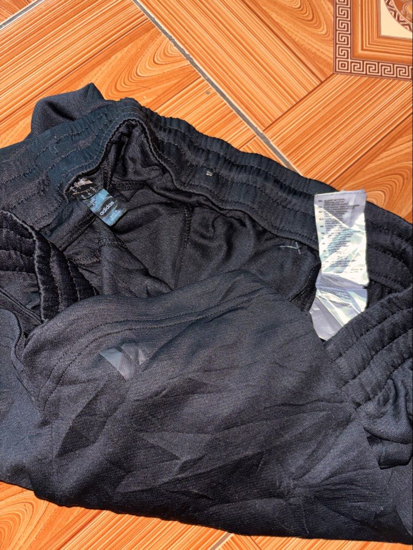 Adidas Black Athletic Shorts (Category: Shorts) located in Polomolok. Submitted by rrthrift (Listing ID 1470500647, Image 3). Description: - Color: Black - Brand: Adidas logo near the hem - Waistband: Elastic with adjustable drawstring - Fit: Regular fit, easy to pair with any tee - Material: Lightweight fabric - Best for: Workouts or casual lounging Size XL 34-40 length 17.