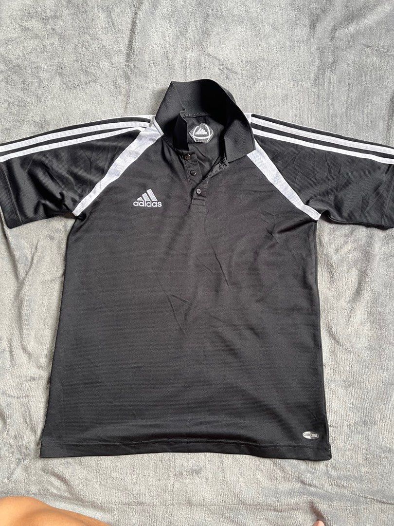 Adidas Black Climacool Polo Shirt (Category: Tshirts & Polo Shirts ) located in Urdaneta. Submitted by m1k3yl (Listing ID 1470370210, Image 1). Description: - Brand: Adidas - Color: Black with white shoulder stripes - Technology: Climacool (breathable and quick-dry) - Style: Short sleeves, classic button placket - Condition: Good overall, ready to wear - Versatility: Ideal for sports, workouts, or casual days.