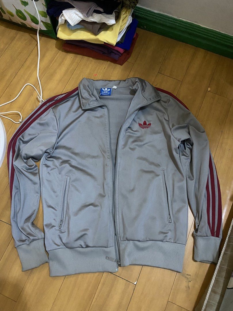 Adidas Vintage Track Jacket (Category: Coats, Jackets and Outerwear) located in Marikina City. Submitted by ctgccc (Listing ID 1470487313, Image 1). Description: Color: Gray and Red stripes Size: Large Damages: none Stains: not too seen from afar.