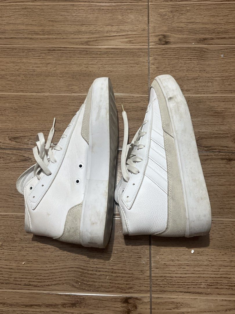 Adidas White High Top Sneakers (Category: Sneakers) located in Tarlac. Submitted by 444_conservative (Listing ID 1470452840, Image 2). Description: - Brand: Adidas - Style: White leather high top sneakers with suede heel and toe panels - Soles: Thick platform with ribbed texture and plenty of tread left - Details: Lace-up closure with metal eyelets - Condition: Regular wear with minor scuff marks and dirt stains on the soles and rubber bumpers.