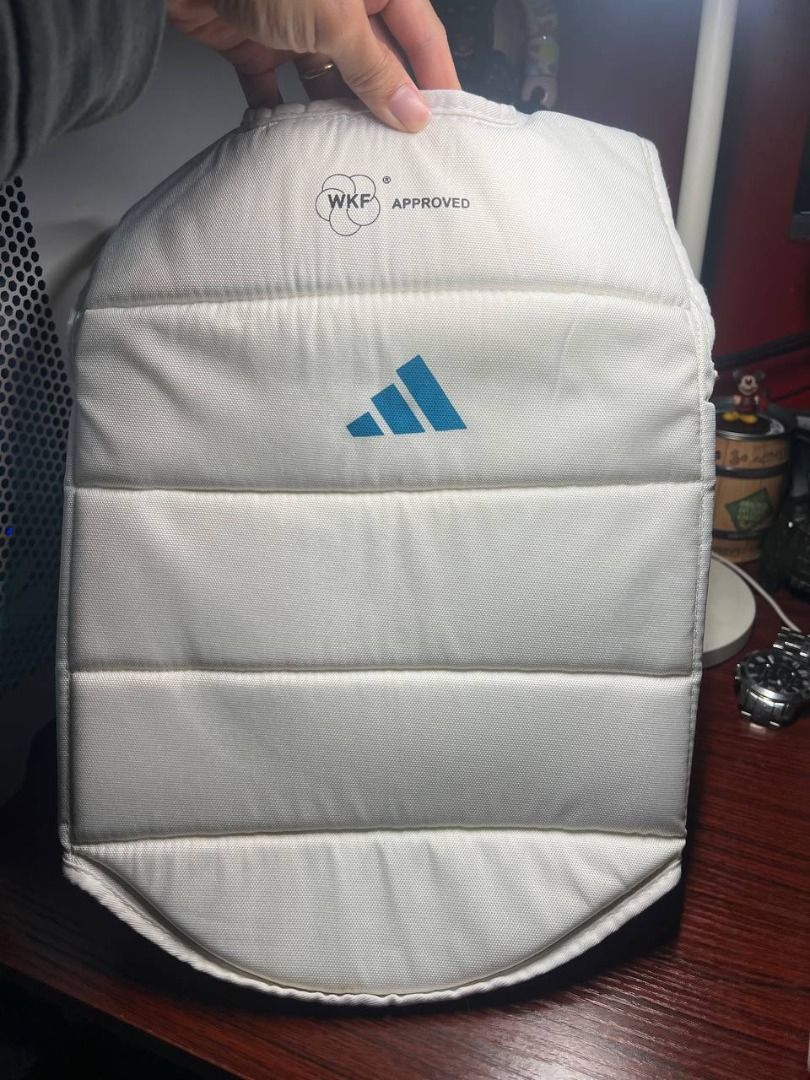Adidas WKF Chest Guard Size M (Category: Combat Sports) located in Baguio. Submitted by carlbenta (Listing ID 1470493809, Image 1). Description: - Brand: Adidas (WKF Approved) - Item: Karate Chest Guard - Color: White with blue branding - Size: Medium - Condition: Brand new with original tags, packaging bag, and manual - Features: Padded front panel, breathable mesh backing, and adjustable elastic back straps for a secure fit Location: BAguio Cit