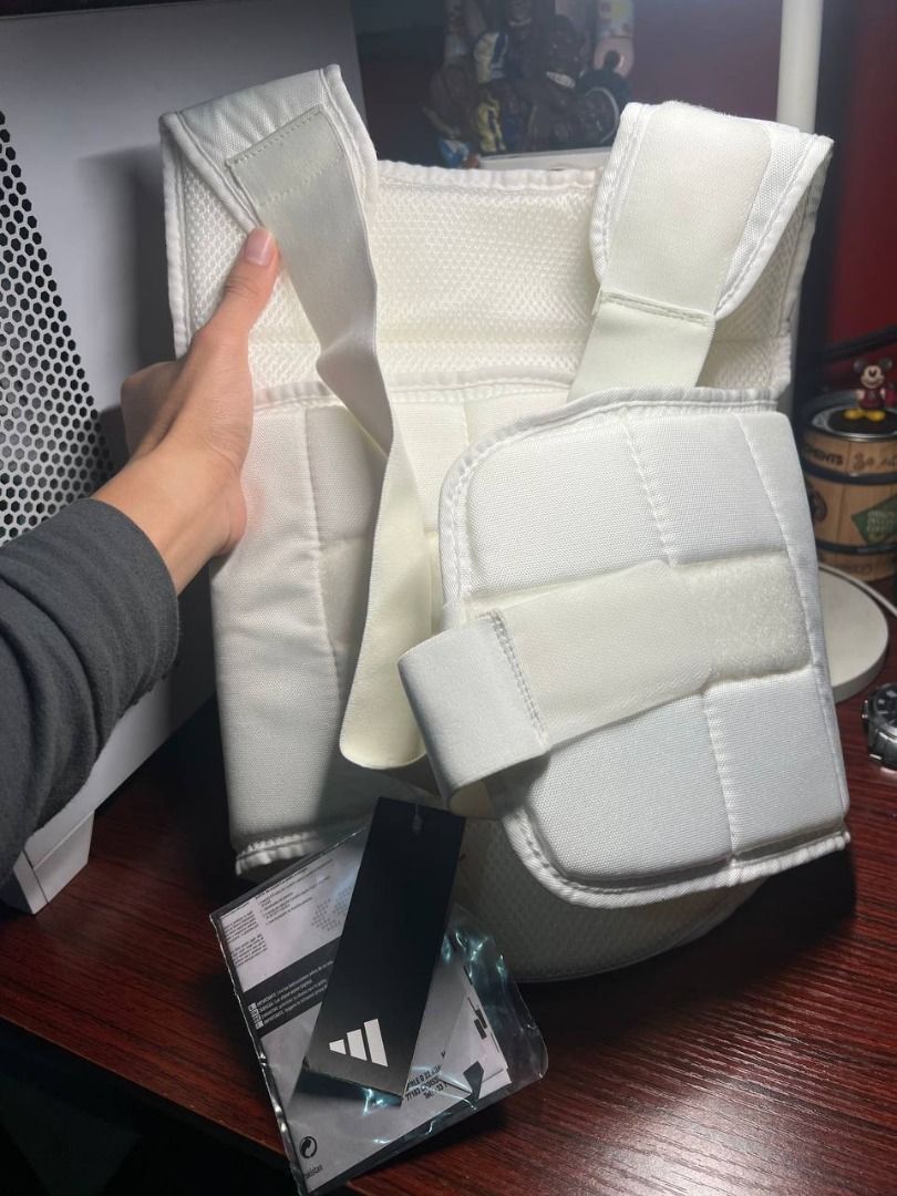 Adidas WKF Chest Guard Size M (Category: Combat Sports) located in Baguio. Submitted by carlbenta (Listing ID 1470493809, Image 2). Description: - Brand: Adidas (WKF Approved) - Item: Karate Chest Guard - Color: White with blue branding - Size: Medium - Condition: Brand new with original tags, packaging bag, and manual - Features: Padded front panel, breathable mesh backing, and adjustable elastic back straps for a secure fit Location: BAguio Cit