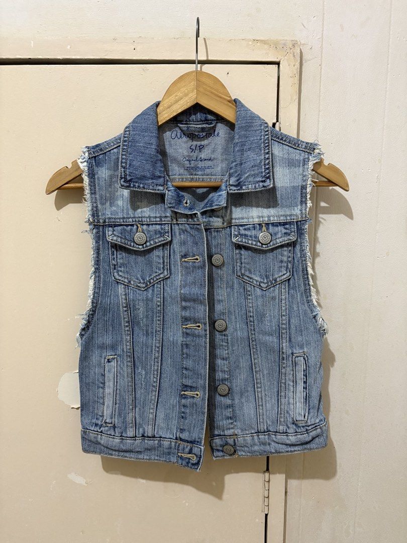 Aeropostale Denim Vest Size S (Category: Sleeveless) located in Manila. Submitted by affordeals (Listing ID 1470461639, Image 1). Description: - Brand: Aeropostale - Size: S - Color: Light blue wash - Design: Button-front closure, collar neckline - Pockets: Chest pockets and lower welt pockets - Details: Raw frayed armholes with distressed accents on the shoulders and back yoke - Fit/Style: Great layering piece for casual outfits.