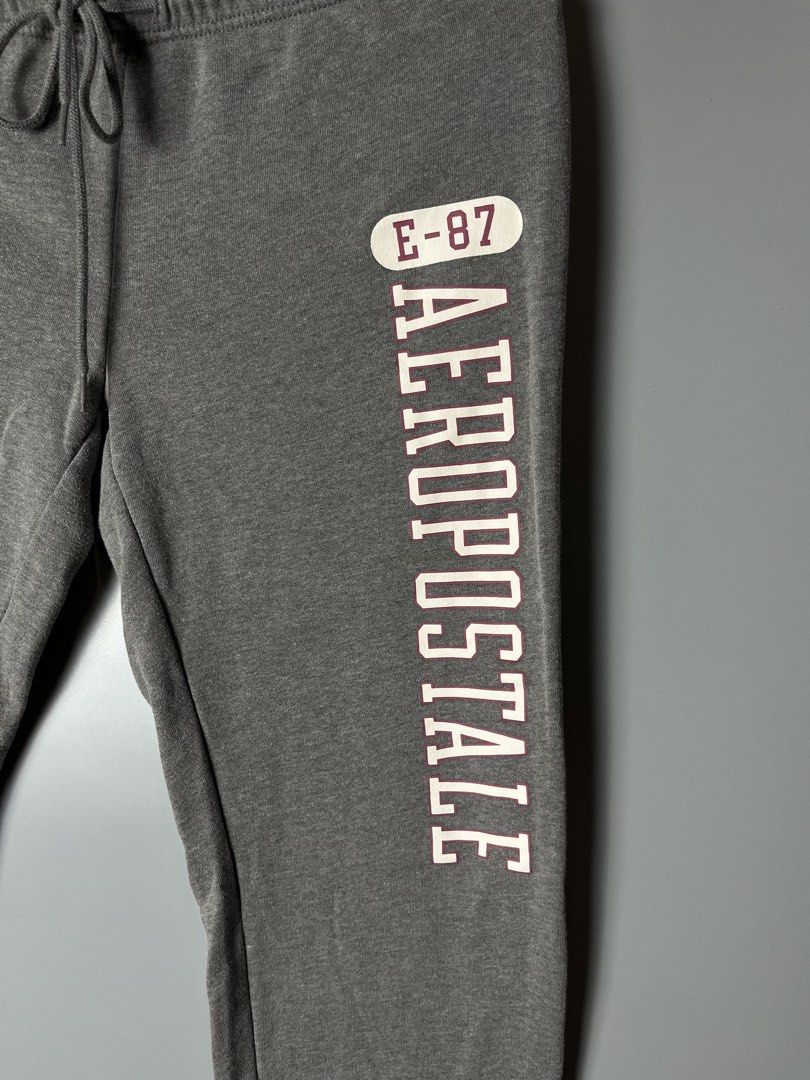 Aeropostale Grey Sweatpants Size M (Category: Joggers) located in Dagupan City. Submitted by loves2thrifth (Listing ID 1470422206, Image 2). Description: - Brand: Aeropostale - Size: Medium (Style 2985) - Color: Grey with white and burgundy logo lettering - Material: Cotton and polyester blend (very soft and warm) - Features: Drawstring waistband and ribbed ankle cuffs - L 35 inches - W 14 inches .