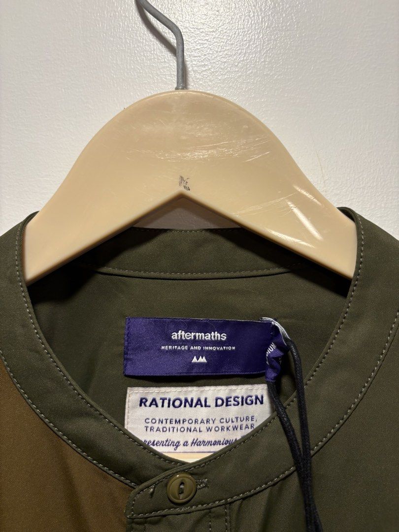 Aftermath Collarless Color-Block Button-Down Utility Shirt (Category: Formal Shirts) located in Bacolod City. Submitted by moboandmoga (Listing ID 1470407936, Image 2). Description: Aftermath collarless color-block button-down utility shirt from the Japanese brand Aftermaths (featuring “Rational Design” branding on the interior tag and hangtag) Size: Large frame Brand new w/hangtag (Sizing info) Width: 22 inches Length: 29Front - 31back.