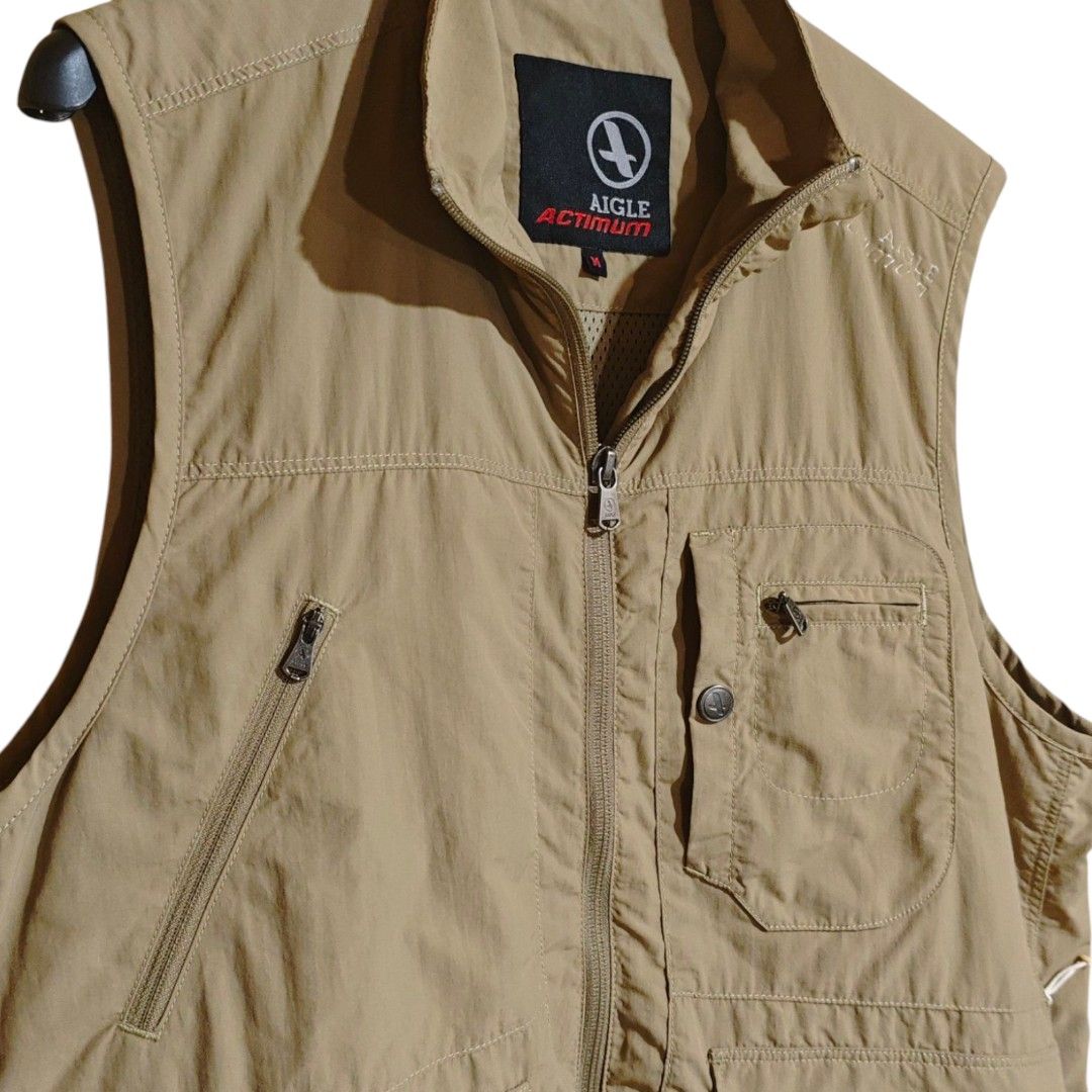 AIGLE Actimum Vintage Technical Utility Vest (Category: Coats, Jackets and Outerwear) located in Quezon City. Submitted by oldturnedtogold (Listing ID 1470349448, Image 3). Description: AIGLE Actimum Vintage Technical Utility Vest Size Medium Beige/Khaki Shoulder Width - 16" Body length - 26" Chest Width - 22" Details: - Authentic Aigle Actimum vintage outdoor line - nylon fabric - lightweight and quick-dry - LOTSSS OF POCKETSSSS (front pockets h