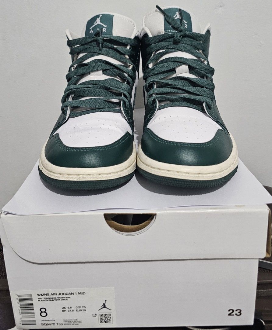 Air Jordan 1 Mid Oxidized Green (Category: Sneakers) located in Paranaque City. Submitted by chigon (Listing ID 1470536431, Image 1). Description: - Model: Women's Air Jordan 1 Mid - Colorway: White and Oxidized Green - Size: US 8 / UK 5.5 / EUR 39 - Includes: Original box with matching style code (BQ6472 133) - Design: Classic high-top silhouette, white leather base, dark green overlays and laces - Condition: Brand new-ish, minor dirt on midsole