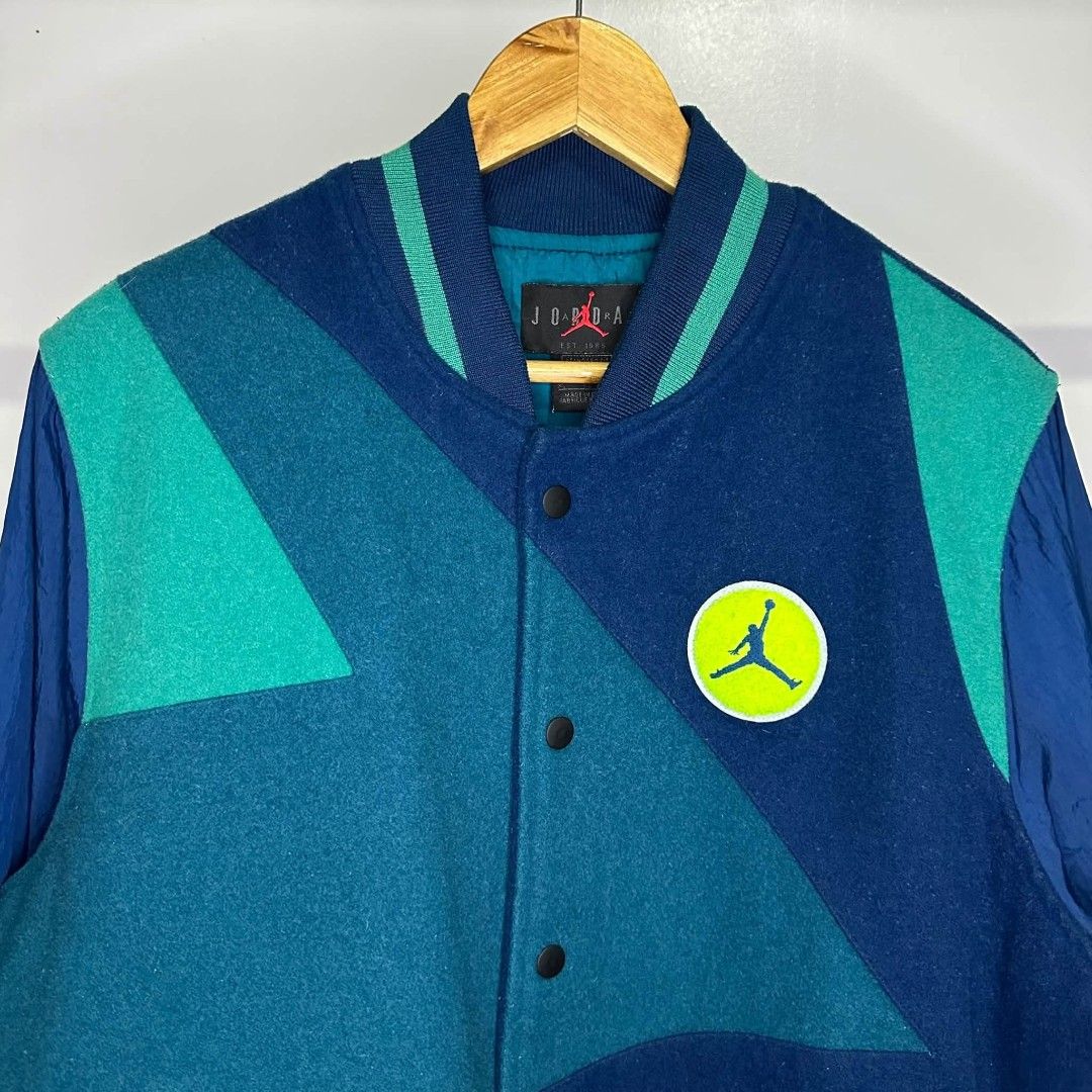 Air Jordan Varsity Jacket Blue Green (Category: Coats, Jackets and Outerwear) located in Manila. Submitted by ggclothings (Listing ID 1470490919, Image 3). Description: - Authentic blue and green Jordan varsity jacket - Premium wool body with durable nylon sleeves - Snap button front closure and convenient front pockets - Large embroidered Air Jordan logo patch on the back - Smaller Jumpman circle patch on the chest - Classic striped ribbed colla