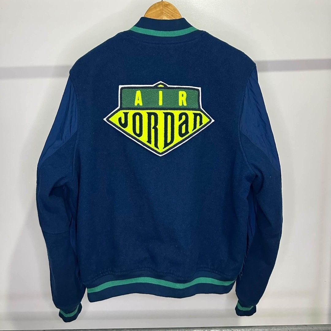 Air Jordan Varsity Jacket Blue Green (Category: Coats, Jackets and Outerwear) located in Manila. Submitted by ggclothings (Listing ID 1470490919, Image 2). Description: - Authentic blue and green Jordan varsity jacket - Premium wool body with durable nylon sleeves - Snap button front closure and convenient front pockets - Large embroidered Air Jordan logo patch on the back - Smaller Jumpman circle patch on the chest - Classic striped ribbed colla
