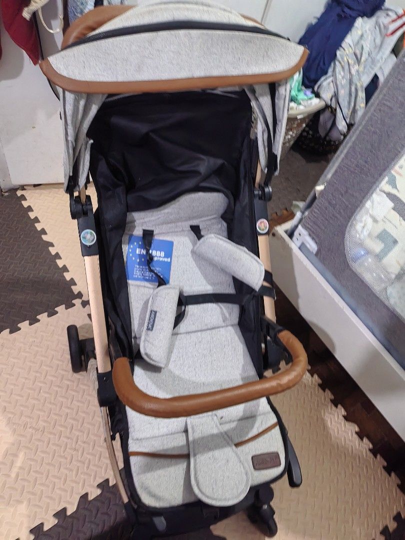 Akeva Baby Stroller Grey with Brown Leather Handle (Category: Strollers) located in Quezon City. Submitted by cjzelaq (Listing ID 1470537908, Image 2). Description: - Brand: Akeva Baby Stroller Halos d anung nagamit kasi ayaw ni baby, labahan nyo nlng, may mga konting dumi sa pag kaka stock Like new. - Color/Design: Stylish grey tweed fabric with brown leather-look handle and bumper bar - Frame: Lightweight with elegant gold-tone accents - Safety