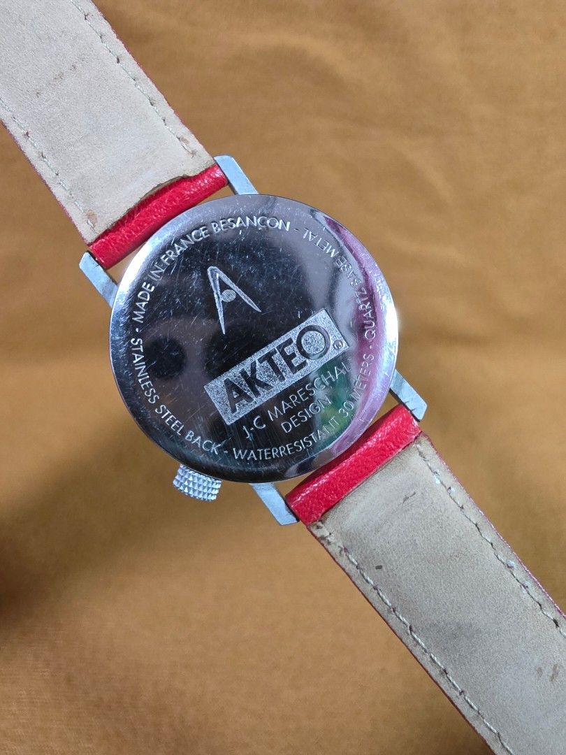 AKTEO J.C. Mareschal Native American Theme Watch (Category: Women's Watches) located in Rosales. Submitted by akumie30 (Listing ID 1470519029, Image 3). Description: - Brand: AKTEO (Designed by J.C. Mareschal) - Theme: Native American inspired dial with unique arrow and tomahawk hands - Case: Stainless steel, made in France - Water Resistance: 30 meters - Strap: Bright red leather with silver crown - Condition: Excellent, highly collectible timep