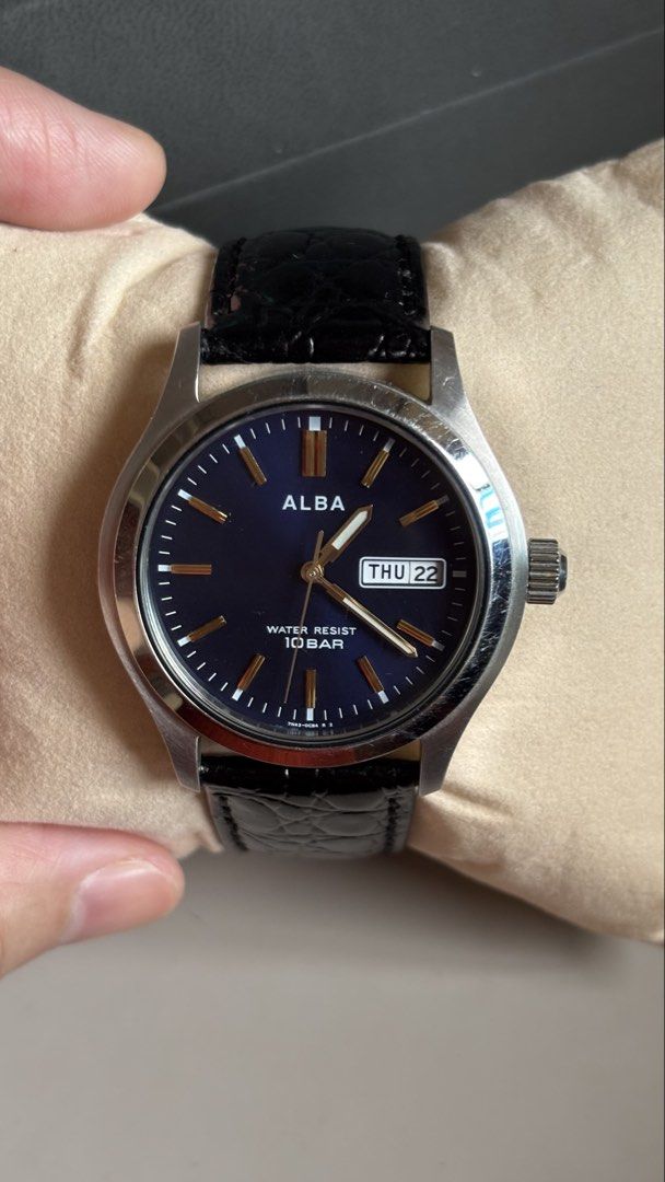 Alba Quartz Blue Dial Day Date Watch (Category: Men's Watches) located in Caloocan City. Submitted by thrift_genieee (Listing ID 1470404955, Image 3). Description: - Brand/Model: Alba Quartz Watch - Dial: Deep blue with gold-tone markers and 3 o'clock day-date window - Case & Strap: Stainless steel case paired with black crocodile-pattern leather strap - Condition: Keeps time accurately, clean look on the wrist, but with noticeable scratches on t