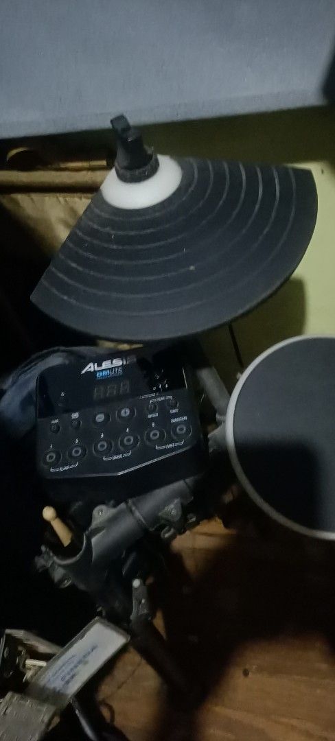 Alesis DM Lite Electronic Drum Kit (Category: Musical Instruments) located in Taguig. Submitted by grandfish_55ab5c (Listing ID 1470517229, Image 3). Description: - Brand/Model: Alesis DM Lite Electronic Drum Set - Inclusions: Sound module, black drum pads, cymbal pads, and sturdy metal frame rack - Features: Blue backlit sound module with digital display and easy control buttons - Condition: Good working condition - Perfect for: Quiet home pract