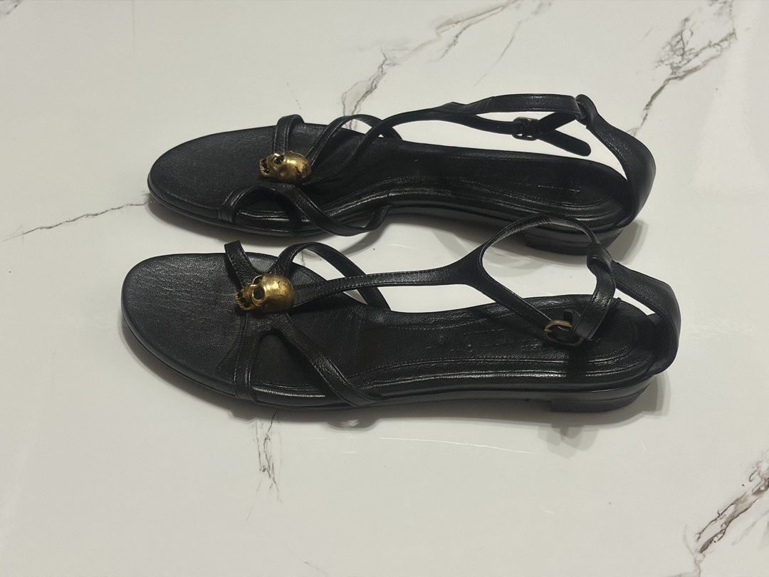 Alexander McQueen Black Leather Skull Flat Sandals (Category: Sneakers & Footwear) located in Balanga. Submitted by momstyle.ph (Listing ID 1470504008, Image 2). Description: Black leather flat sandals by Alexander McQueen. Signature gold tone skull hardware on the front straps. Adjustable ankle strap with buckle closure. Made in Italy. Size 37 SALE PRICE💕.