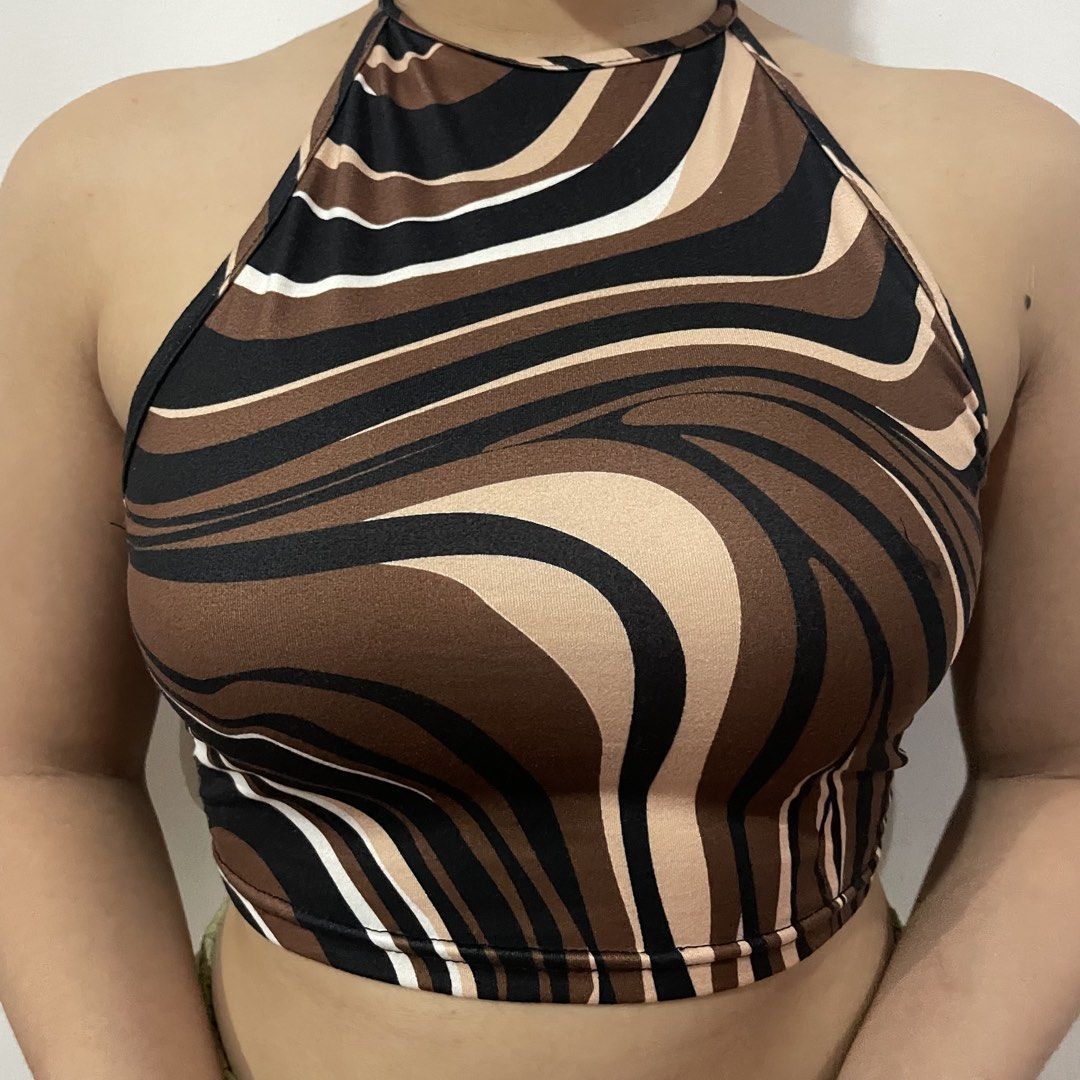 Allover Print Halter Top Swirl Pattern Brown Black (Category: Sleeveless) located in Iligan City. Submitted by lisiantbel (Listing ID 1470529524, Image 2). Description: - Trendy brown, black, and white swirl print - Flattering crop length style - Adjustable neck strap for a custom fit - Soft and stretchy fabric for all-day comfort - Versatile piece for summer days or night outs.