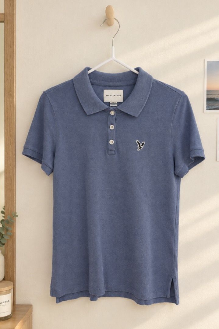 American Eagle Blue Polo Shirt (Category: Shirts) located in Las Pinas. Submitted by shop.reyts (Listing ID 1470434555, Image 1). Description: - Brand: American Eagle - Color: Classic blue - Material: Soft cotton blend - Design: Short sleeves, standard collar, three-button placket - Details: Small embroidered eagle logo patch, side slits at hem -Length: 23in , width 14.5in -Shoulder to shoulder; 20in.