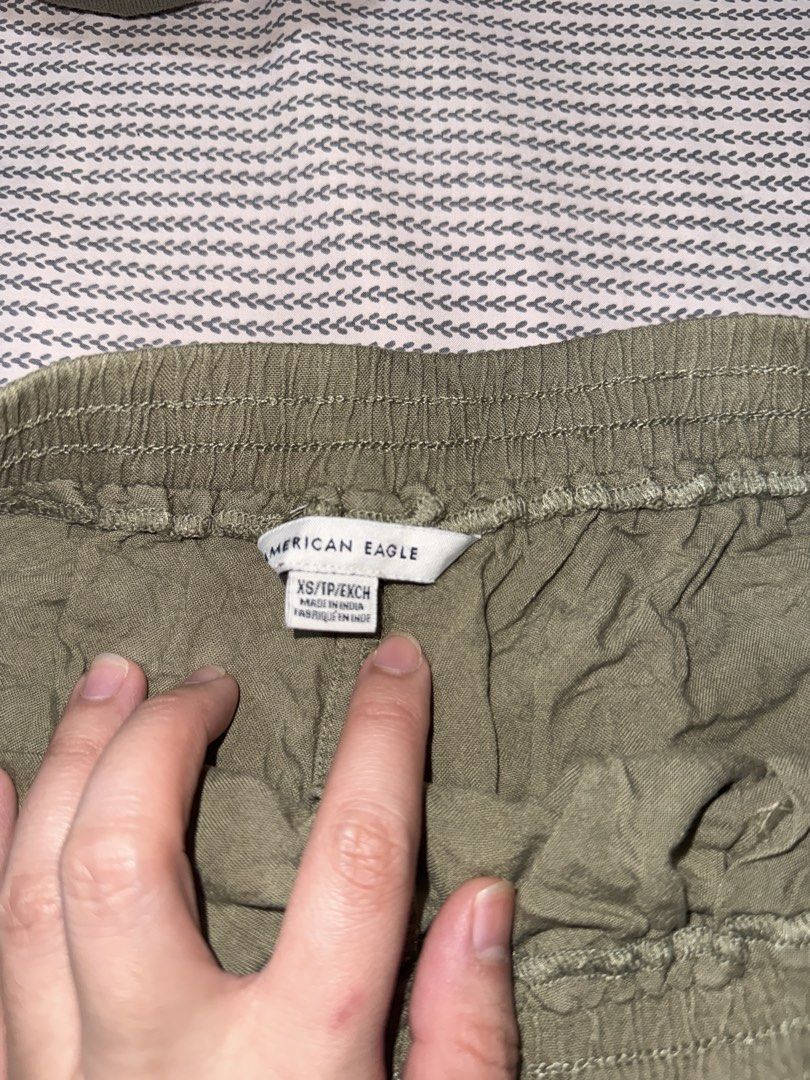 American Eagle Olive Green Ruffle Shorts XS (Category: Shorts) located in Santa Ana. Submitted by fatikilla (Listing ID 1470378417, Image 2). Description: - Brand: American Eagle - Size: XS - Color: Olive Green - Material: Super soft and comfortable fabric - Waistband: Elastic with a functional drawstring for easy pull-on style - Details: Cute ruffle hem at the bottom - Pockets: Convenient deep side pockets - Condition: Excellent/Great for casual