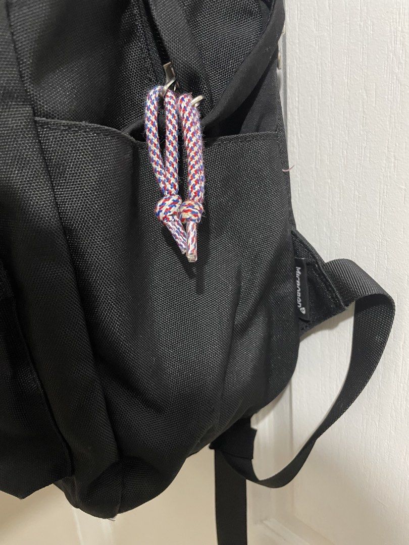 American Tourister Black Backpack (Category: Backpacks) located in Naga. Submitted by thriftboss88 (Listing ID 1470481215, Image 3). Description: - Brand: American Tourister - Color: Classic Black - Material: Durable canvas - Front zipper pocket with stylish red, white, and blue stripe detail and braided cord pull - Two convenient side slip pockets for water bottles or essentials - Adjustable, padded black shoulder straps for all-day comfort - St