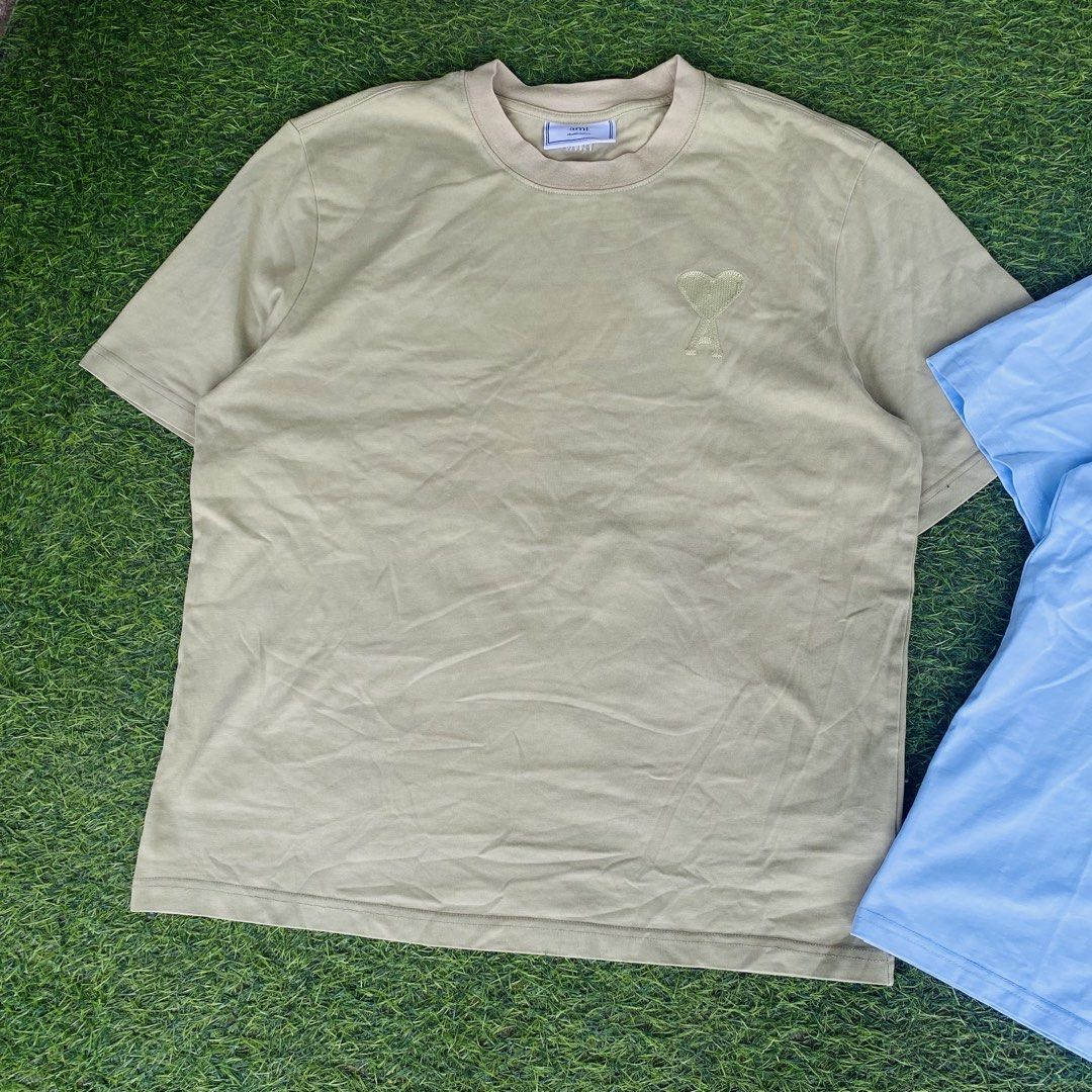 Ami Paris T-Shirt Bundle - Olive Green & Light Blue (Category: Shirts) located in Manila. Submitted by markuztimo62237 (Listing ID 1470385907, Image 3). Description: - Brand: Ami Paris - Items: 2 crewneck t-shirts (Bundle pair) - Colors: Olive Green & Light Blue - Details: Signature tonal heart logo embroidered on chest - Fit: Short sleeves, relaxed fit - Material: Soft, premium cotton for daily wear - Perfect for minimalist styling.