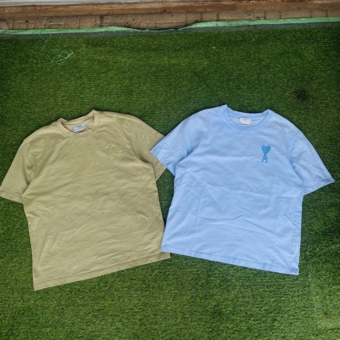 Ami Paris T-Shirt Bundle - Olive Green & Light Blue (Category: Shirts) located in Manila. Submitted by markuztimo62237 (Listing ID 1470385907, Image 2). Description: - Brand: Ami Paris - Items: 2 crewneck t-shirts (Bundle pair) - Colors: Olive Green & Light Blue - Details: Signature tonal heart logo embroidered on chest - Fit: Short sleeves, relaxed fit - Material: Soft, premium cotton for daily wear - Perfect for minimalist styling.