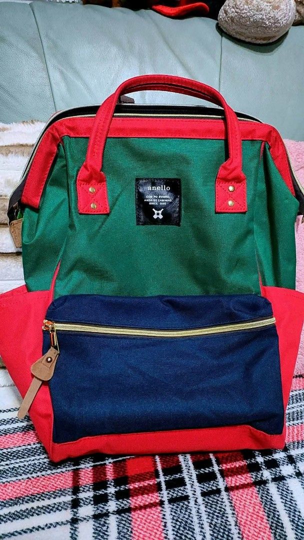 Anello Multicolored Canvas Backpack Green Red Blue (Category: Backpacks) located in Baliuag. Submitted by marieannfernando23 (Listing ID 1470370026, Image 2). Description: - Brand: Anello - Material: Durable Canvas - Colorway: Green body, red trim and handles, dark blue front pocket - Features: Signature wide rectangular frame opening, spacious main compartment with zipper closure - Pockets: Front zip pocket and convenient side pockets - Straps: 