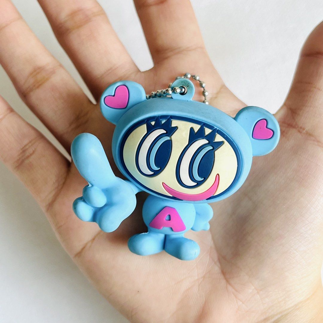 Angel Blue Keychain (Category: Character Goods) located in Cabuyao City. Submitted by nyannyancore (Listing ID 1470363172, Image 3). Description: - Adorable light blue rubber keychain featuring a cute big-eyed cartoon character - Cute pink heart ear details and pink letter A on the chest - Back features copyright text with a small pink star at the bottom - Comes with a sturdy metal ball chain attachment - Compact and lightweight, fits comfortably