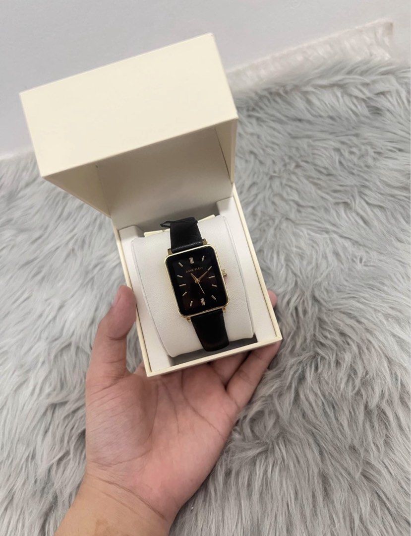 Anne Klein Rectangular Watch Black Gold (Category: Women's Watches) located in Manila. Submitted by allysamaligaya28 (Listing ID 1470512921, Image 1). Description: - Brand: Anne Klein - Condition: Brand new, never used, clean condition - Design: Rectangular gold-tone case with a sleek black dial - Markers & Hands: Elegant gold-tone - Strap: Slim black leather strap - Inclusions: Complete with original cream-colored presentation box and cushion - 