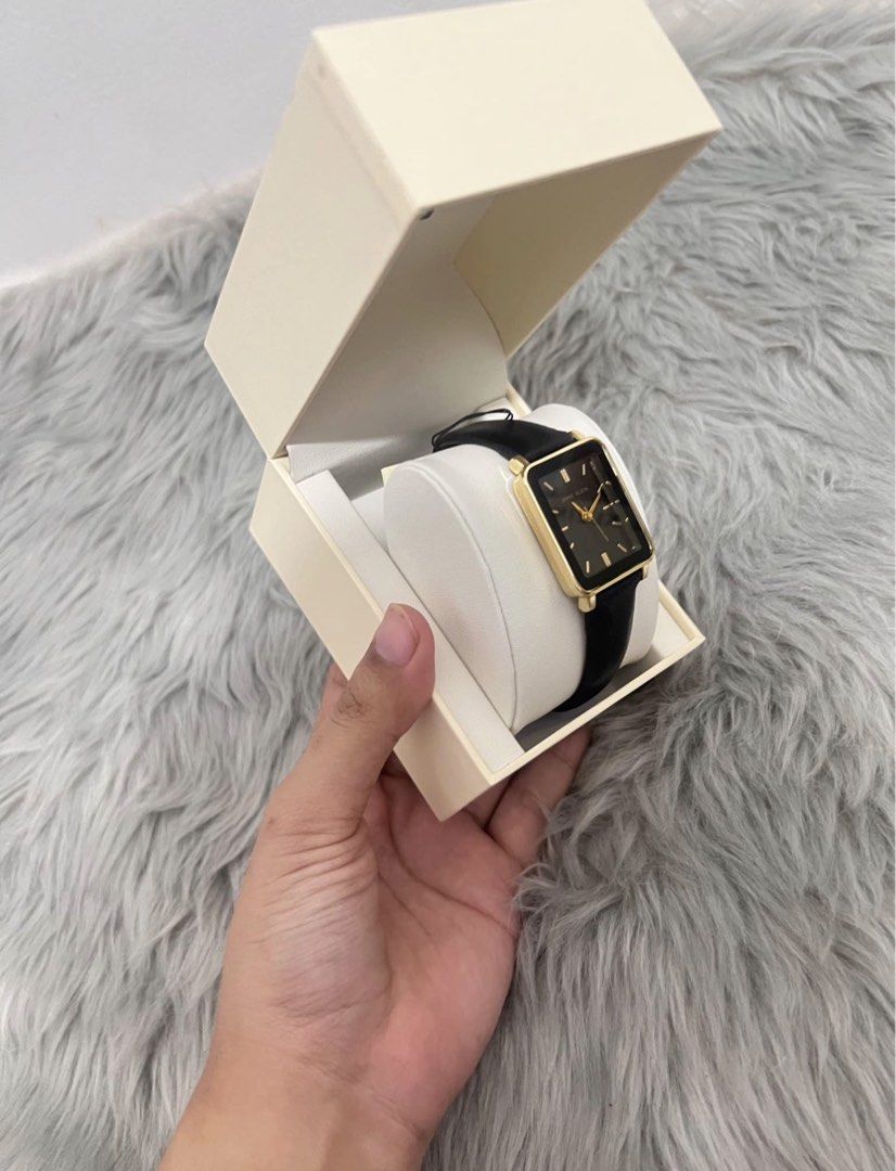 Anne Klein Rectangular Watch Black Gold (Category: Women's Watches) located in Manila. Submitted by allysamaligaya28 (Listing ID 1470512921, Image 2). Description: - Brand: Anne Klein - Condition: Brand new, never used, clean condition - Design: Rectangular gold-tone case with a sleek black dial - Markers & Hands: Elegant gold-tone - Strap: Slim black leather strap - Inclusions: Complete with original cream-colored presentation box and cushion - 