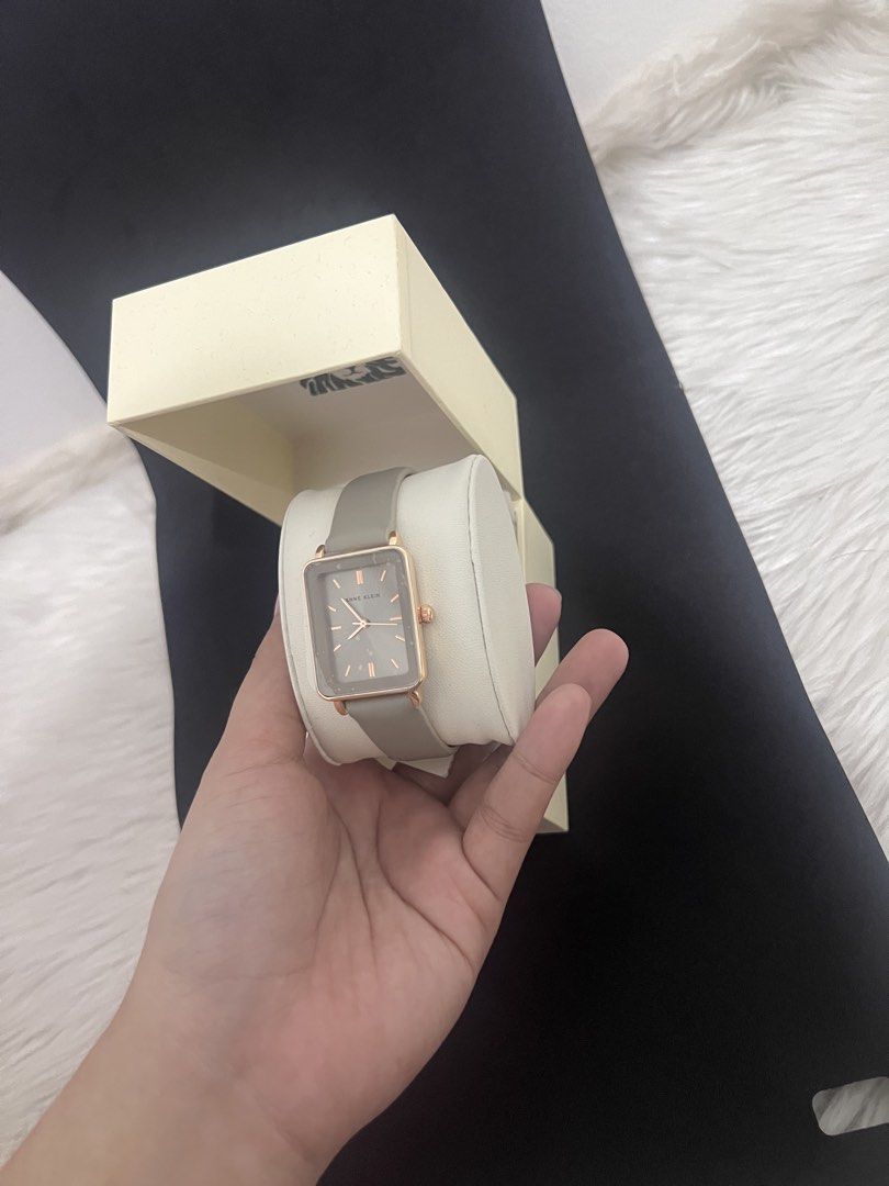 Anne Klein Rectangular Watch With Grey Leather Strap (Category: Women's Watches) located in Manila. Submitted by allysamaligaya28 (Listing ID 1470513223, Image 2). Description: - Brand: Anne Klein - Condition: Brand new, never worn with tag attached - Case & Hands: Rose gold-tone rectangular case with matching hour markers and hands - Dial: Chic grey dial - Strap: Matching grey leather strap with secure pin buckle closure - Inclusion: Comes with 