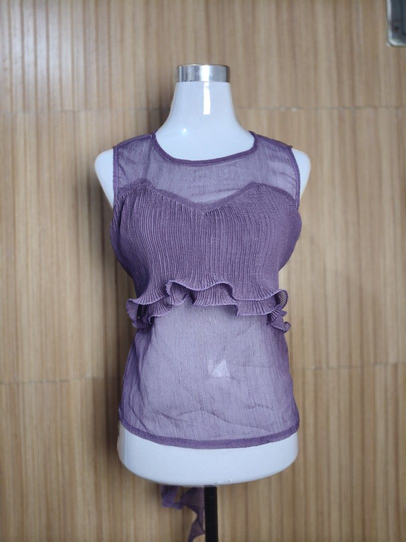 A'postrophe Sheer Midrib Ruffled Top Purple (Category: Sleeveless) located in Taguig. Submitted by ashie_clothing (Listing ID 1470367122, Image 1). Description: - Brand: A'postrophe - Condition: Brand new with original retail tag attached - Color: Purple - Style: Sleeveless midrib top with a scoop neckline - Design: Semi-sheer fabric with layered ruffles - Back Details: Cute bow tie with cascading ruffles.