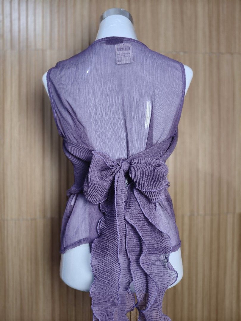 A'postrophe Sheer Midrib Ruffled Top Purple (Category: Sleeveless) located in Taguig. Submitted by ashie_clothing (Listing ID 1470367122, Image 3). Description: - Brand: A'postrophe - Condition: Brand new with original retail tag attached - Color: Purple - Style: Sleeveless midrib top with a scoop neckline - Design: Semi-sheer fabric with layered ruffles - Back Details: Cute bow tie with cascading ruffles.