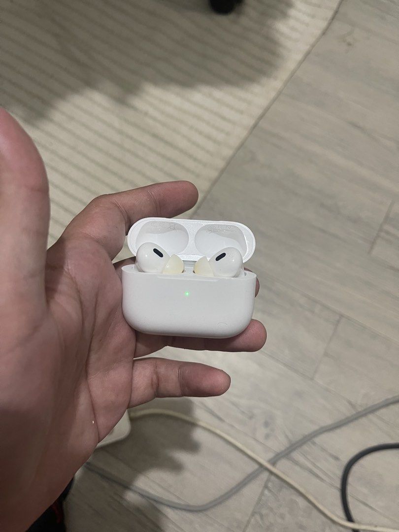 Apple AirPods Pro 2 type c charging case (with box and extra buds) (Category: Earphones) located in Manila. Submitted by keruuben (Listing ID 1470464875, Image 1). Description: - Genuine Apple wireless earbuds with charging case - Working green status light and battery indicator on the front - Fully accessible setup button on the back of the case - Clean interior layout with functional charging slots.