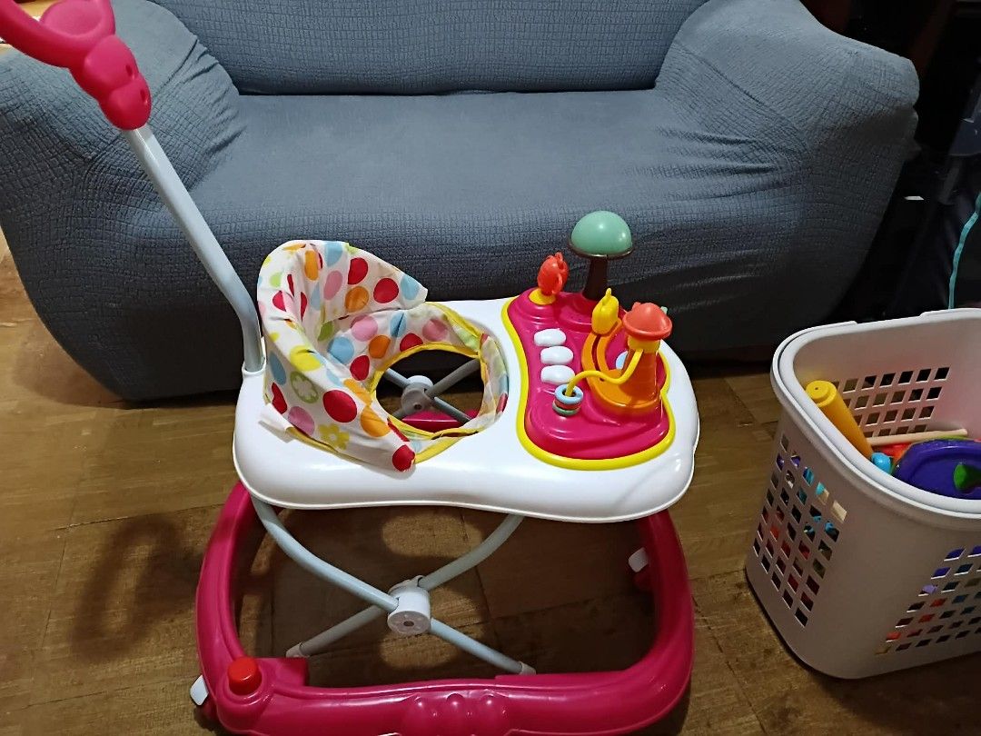 Apruva Baby Walker (Category: Infant Playtime) located in Taguig. Submitted by javinmonkiel (Listing ID 1470391692, Image 2). Description: Selling an Apruva baby walker in white and pink with a cute polka dot seat. Features a parent push handle, fun activity tray with toys, and smooth wheels. Removable seat pad for easy cleaning. Still in very good condition! Less than 1 year of use Clean and well-maintained Sounds still working! RFS: No longer u